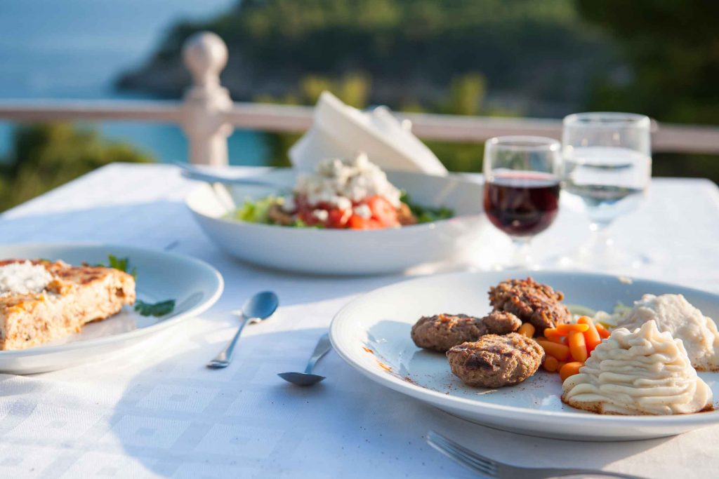 Eating Greek dishes by the sea at the hotel's restaurant